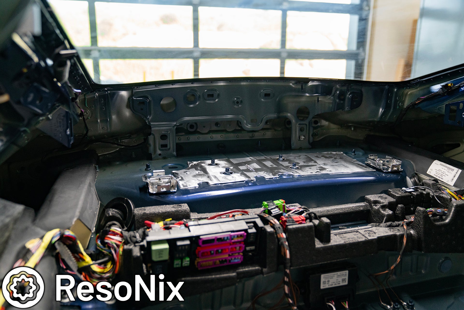 Rear interior of a 992 Porsche 911 GT3 Touring with trim panels removed in preparation of installing ResoNix Sound Solutions CLD Squares sound deadening material and Fiber Mat sound absorbing and thermal insulation material