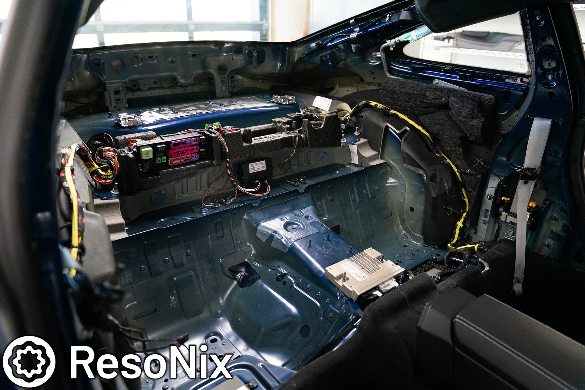 Rear interior of a 992 Porsche 911 GT3 Touring with trim panels removed in preparation of installing ResoNix Sound Solutions CLD Squares sound deadening material and Fiber Mat sound absorbing and thermal insulation material