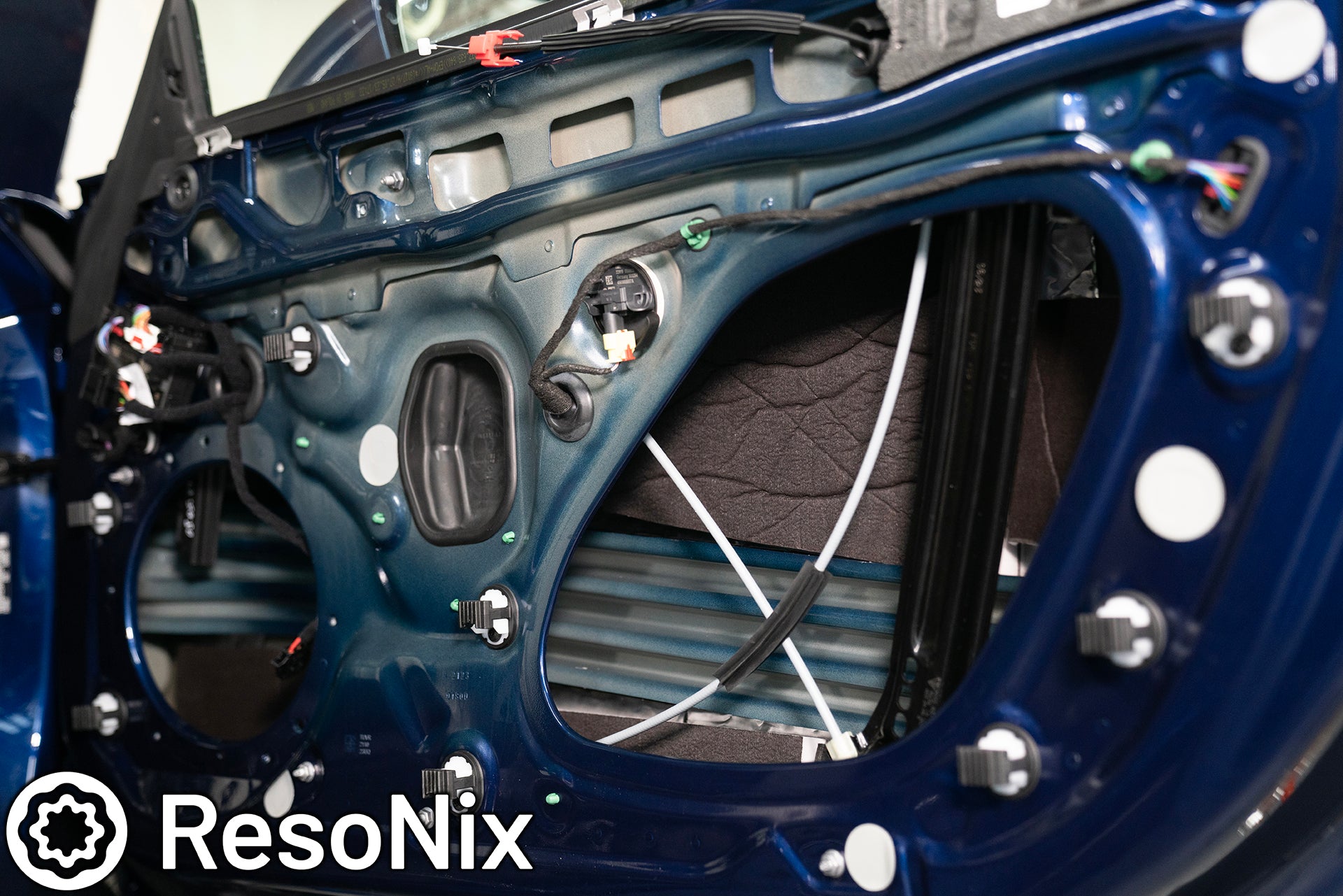 ResoNix Sound Solutions Guardian hydrophobic melamine and MLV door midbass rear wave sound absorber installed into the door of a Porsche 911 to reduce distortion from the audio system and reduce outside wind and tire noise