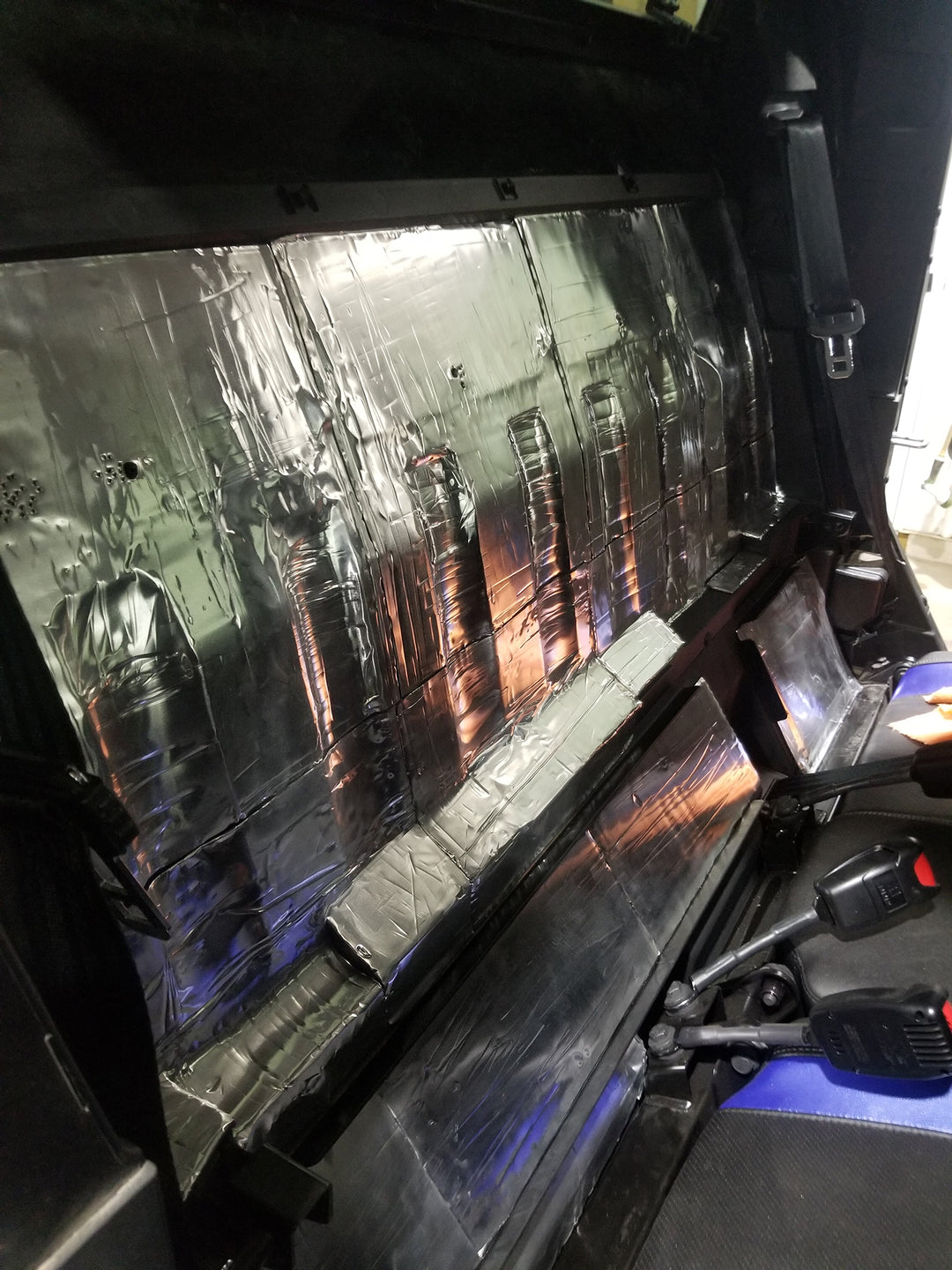 ResoNix Sound Solutions Mega CLD Squares Sound deadening material installed onto the interior firewall of a Polaris Xpedition to reduce sound from the engine