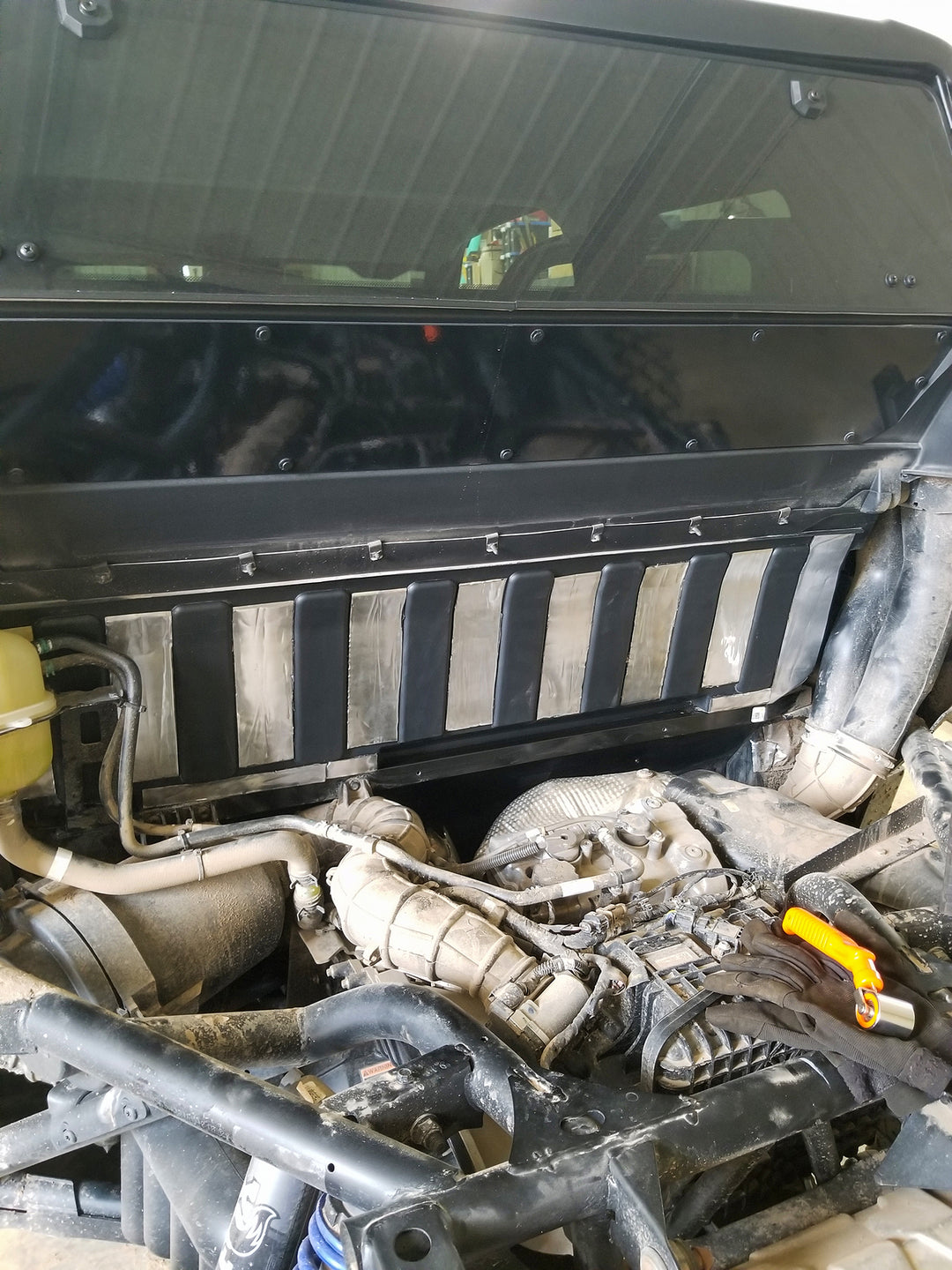 ResoNix Sound Solutions Mega CLD Squares Sound deadening material installed onto the firewall of a Polaris Xpedition to reduce sound from the engine