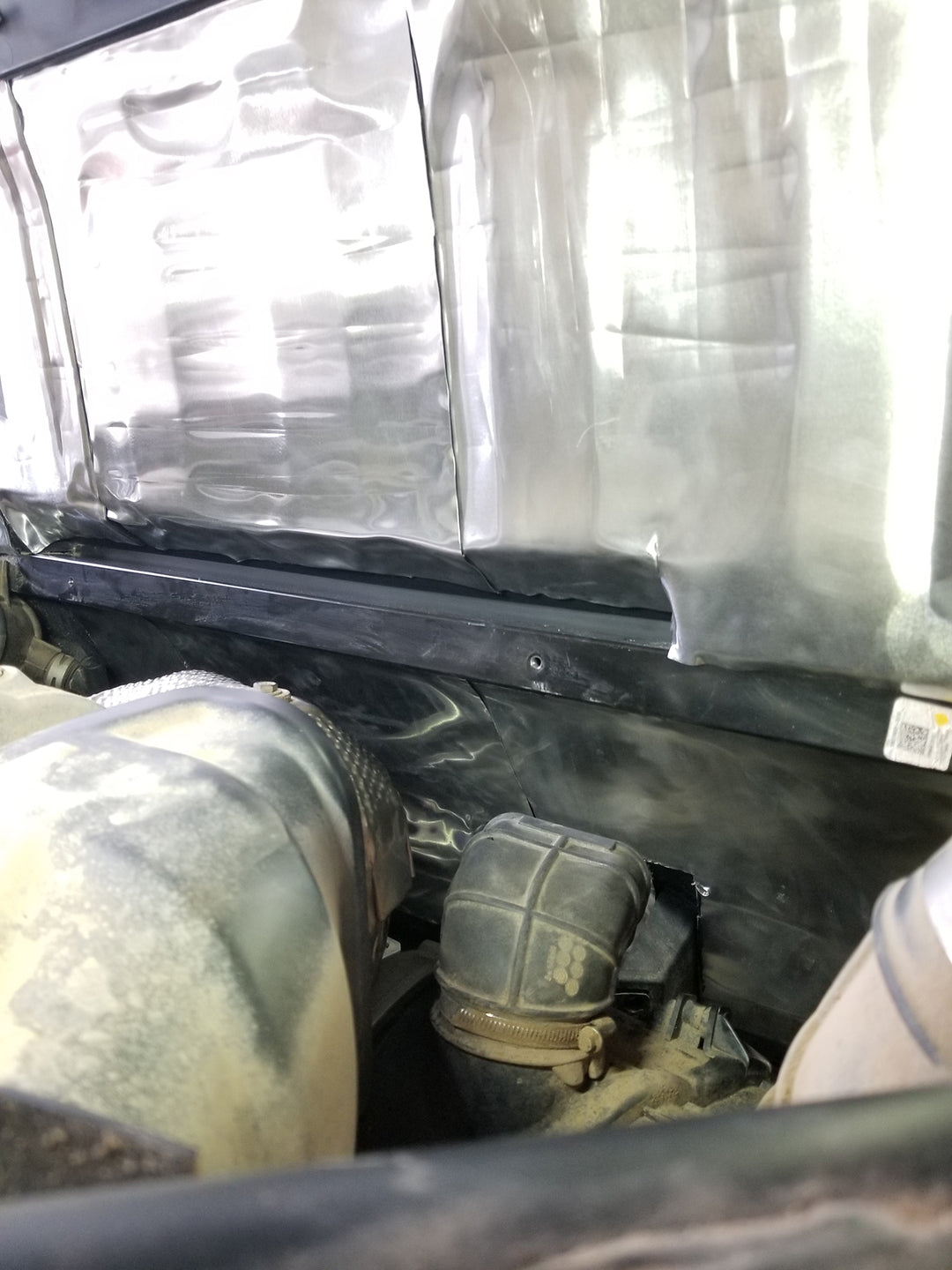 ResoNix Sound Solutions Mega CLD Squares Sound deadening material installed onto the exterior firewall of a Polaris Xpedition to reduce sound from the engine