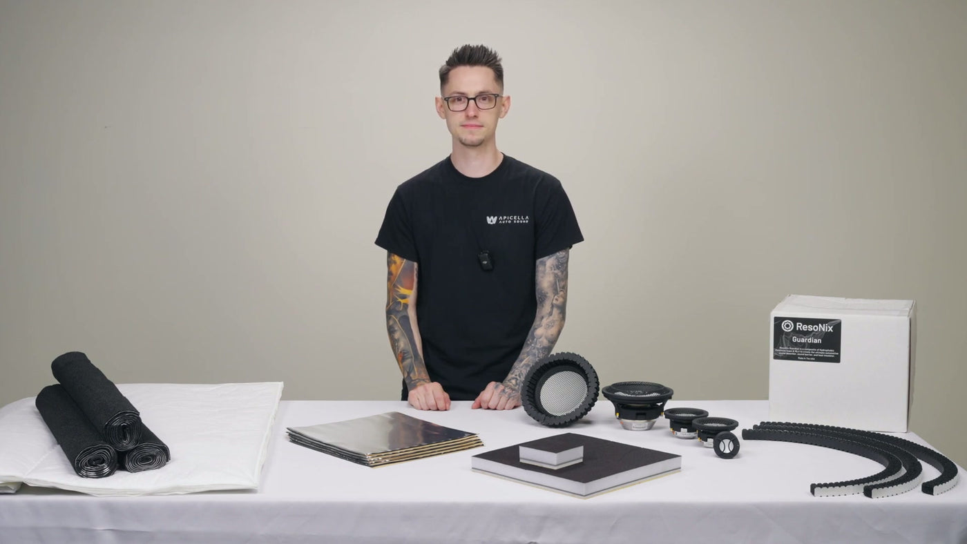 Nick Apicella of ResoNix Sound Solutions standing in front of a table with ResoNix sound deadening materials on it