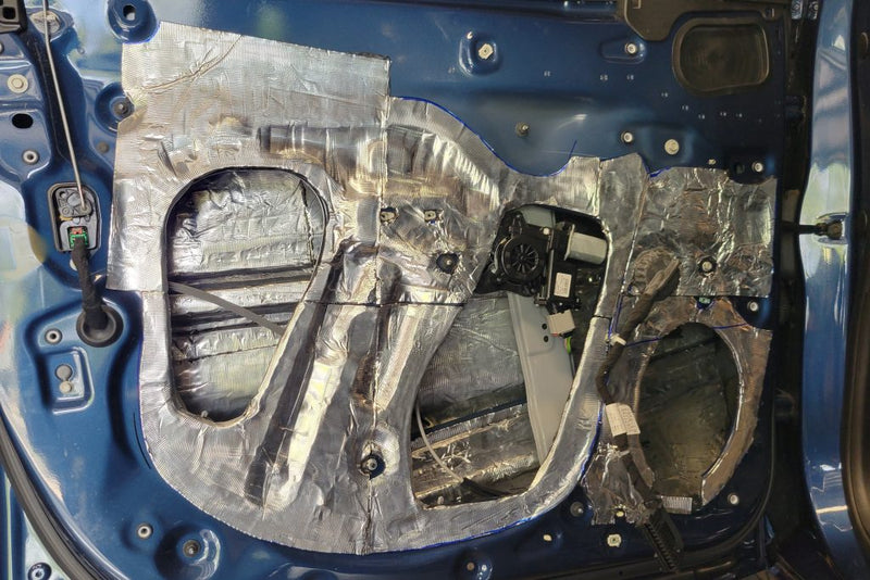 Chevy Silverado door that has ResoNix CLD Squares automotive sound deadening material applied to it.