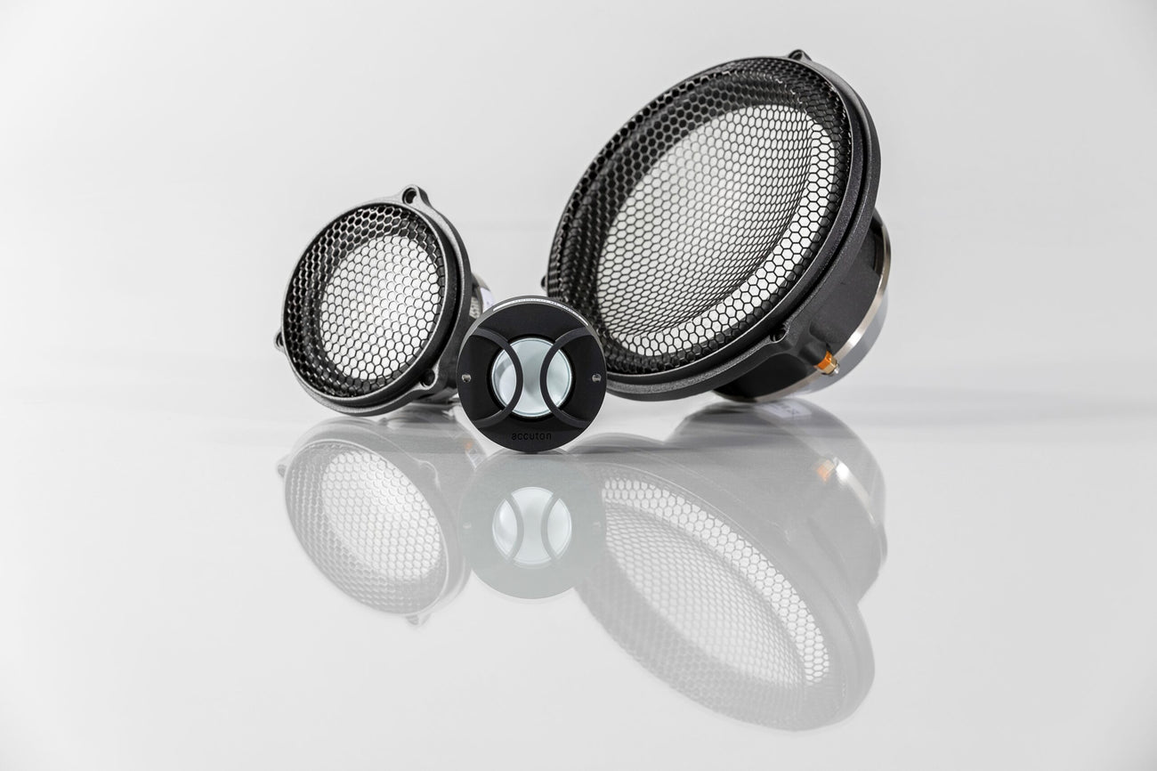 3-way set of Automotive Accuton Ceramic tweeter, midrange, and midbass car audio speakers with white color cones displayed on a reflective surface