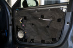 car door with door panel removed showing the inner door skin that is treated with ResoNix Barrier mlv replacement material and an Accuton Automotive C165AM 6.5" midbass speaker installed