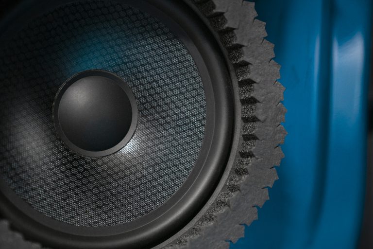 Close up picture of ResoNix Sound Solutions Strips Fast Rings Speaker Foam Ring installed around a car door mounted midbass speaker for better midbass performance