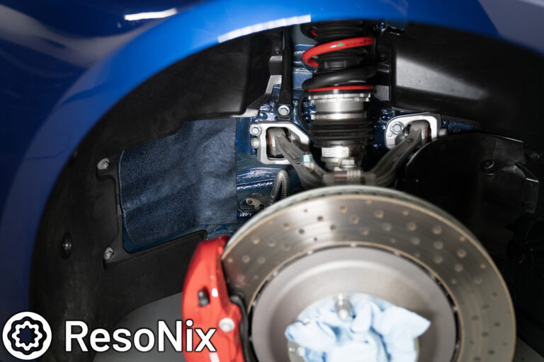 ResoNix Sound Solutions CLD Squares sound deadening material installed onto the front outer wheel well of a Porsche 992 911 GT3 to reduce tire, road, and rock ping noise