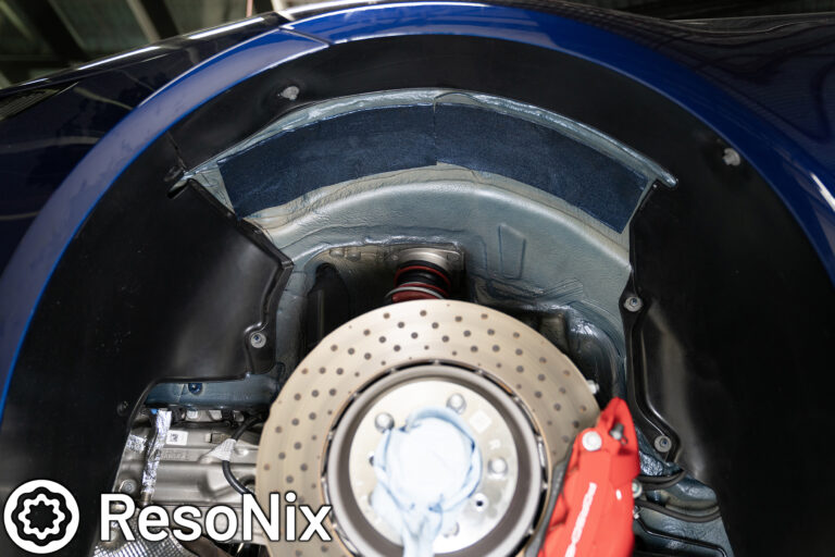 ResoNix Sound Solutions CLD Squares sound deadening material installed onto the rear outer wheel well of a Porsche 992 911 GT3 to reduce tire, road, and rock ping noise