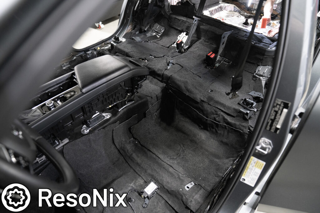 ResoNix Sound Solutions Barrier MLV (mass loaded vinyl) replacement installed onto the floor of a car to block and reduce outside noise